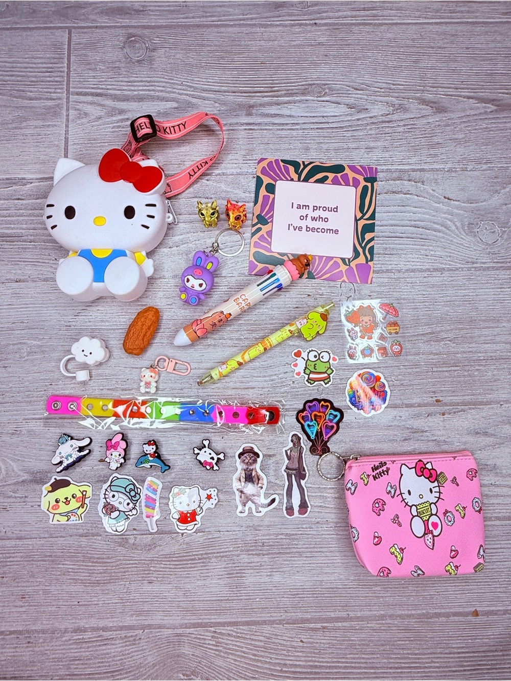 Hello kitty purse bundle pens , stickers , keychain , croc charm bracelet dragon